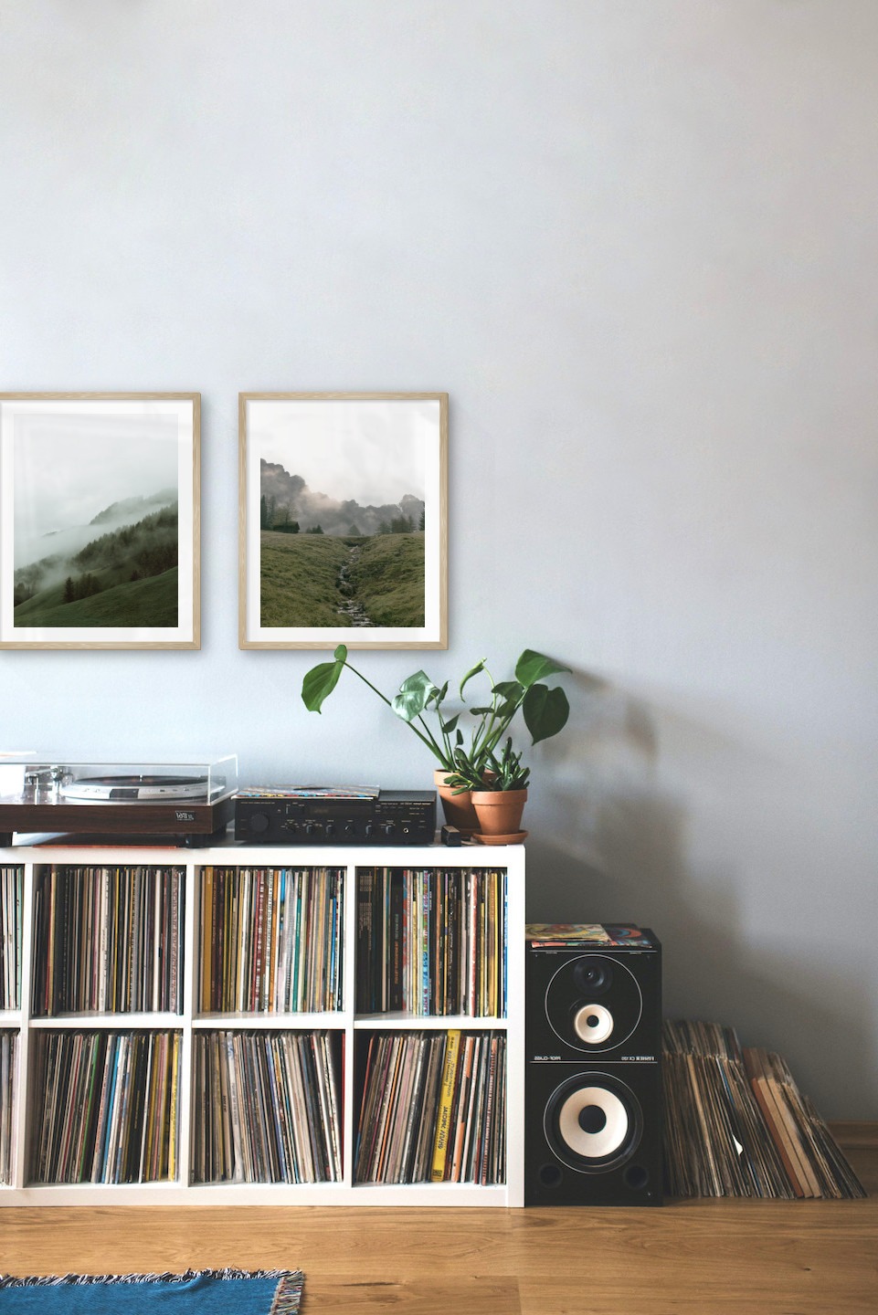 Tavelvägg med ramar i trä i storlekar 40x50 med posters med "Dimmig sluttning" och "Grön dal framför berg"
